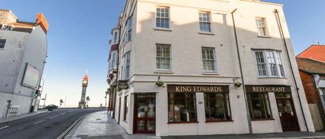 A building with a sign reading "KING EDWARDS RESTAURANT" on the ground floor.