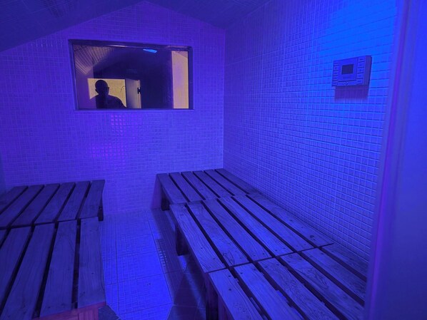 A sauna room with wooden benches and a window.