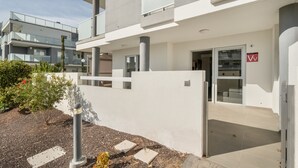 A modern building with a flat roof, large windows, and a white exterior.