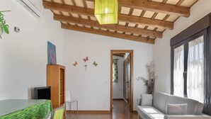 A room with a dining area, a sofa, and a wooden ceiling. - Couple Retreat in Conil, With a Pool (Conil de la Frontera)