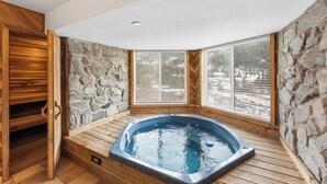 A hot tub in a corner with stone walls and wooden flooring. - Cr2232k-2 (Keystone)