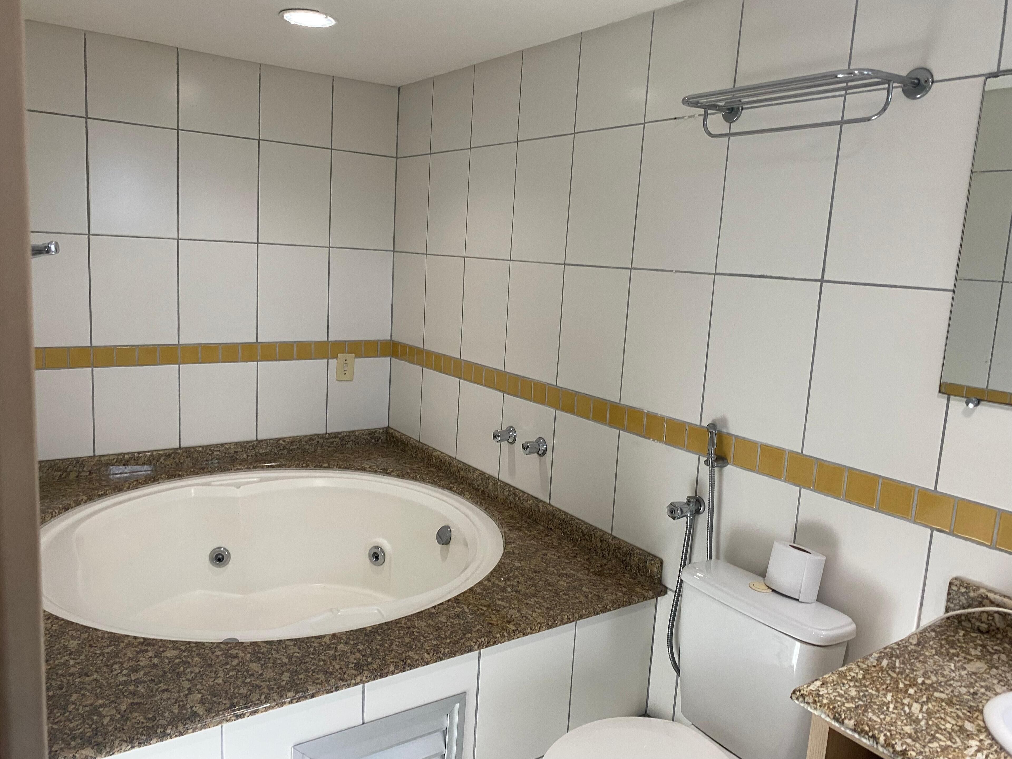 A bathroom with a bathtub, toilet, and sink.