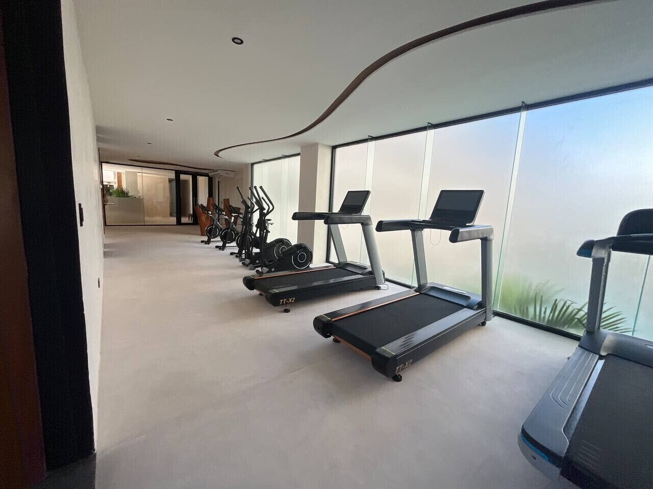A modern gym with treadmills and exercise equipment.