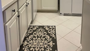 A kitchen with white cabinets, a built-in dishwasher, a refrigerator, and a sink. - Legends Country Club Social 2/2 Condo Overlooking Hole #1, Close to Country Club (Fort Myers)