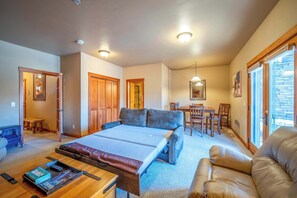 A spacious living room with a large bed, a sofa, and a dining area. - ElkPoint 3 - Ski-In/Out Durango Townhome, Pets OK (Durango)