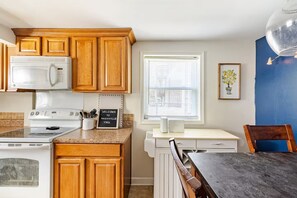 Kitchen and dining space with light wood cabinets and a nearby dining table. - Nashville Getaway with Workspace & Pets (Nashville)