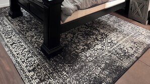 A bedroom with a bed, a nightstand, a window with blinds, and a patterned rug. - Family Retreat with pool table and double bunks. (Bethany)