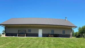 A large, single-story building with a flat roof and a central entrance. - Family Retreat with pool table and double bunks. (Bethany)