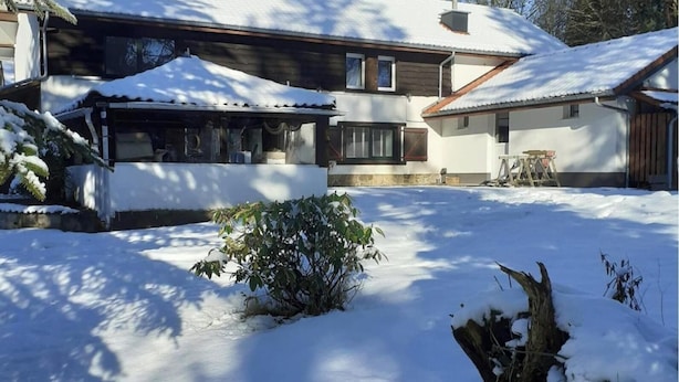 A two-story house with a snow-covered roof and yard. - Holiday Home in Ruisseau de Vaux (Villers-le-Bouillet)