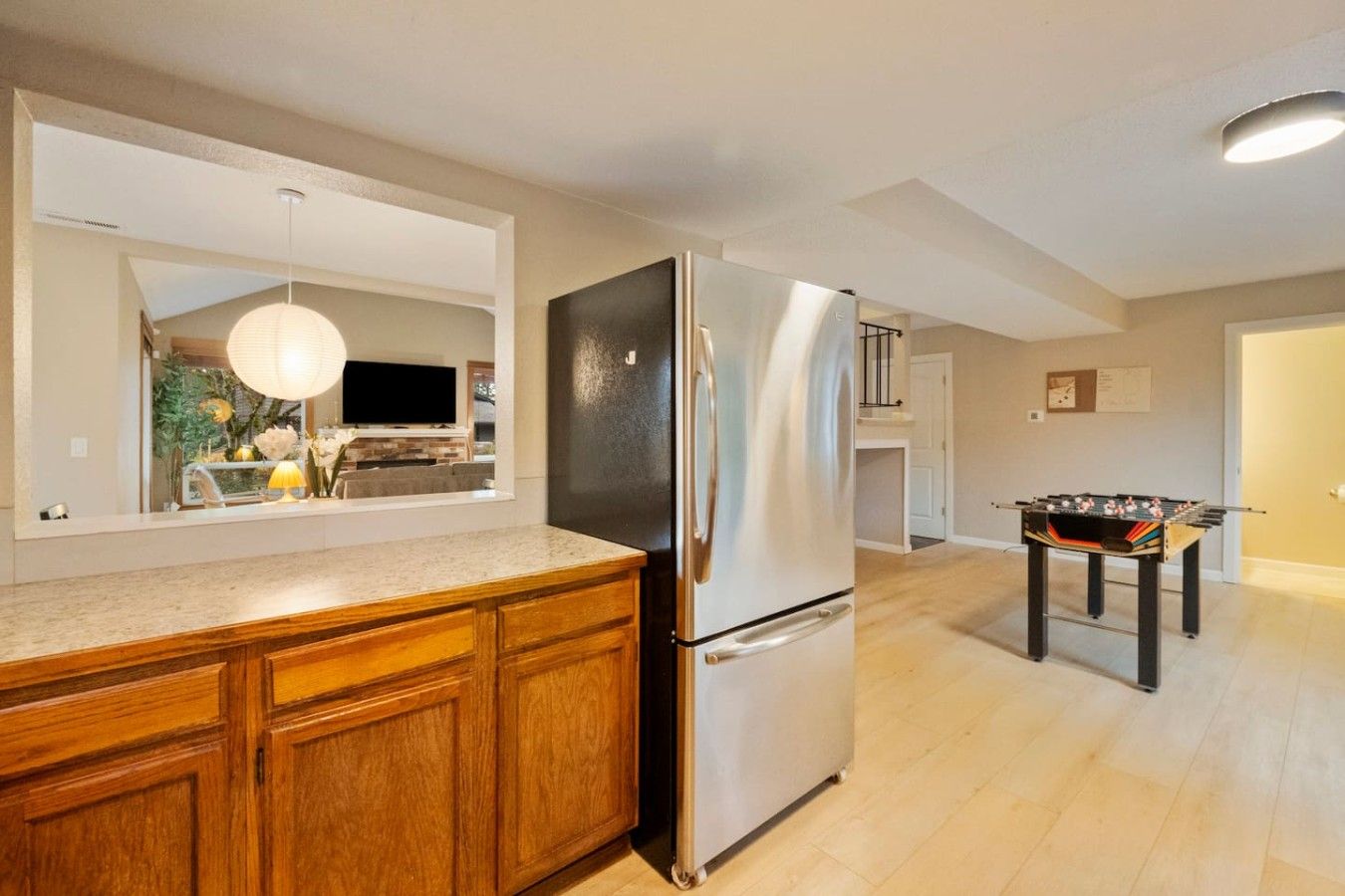A modern kitchen with a built-in refrigerator and wooden cabinets.