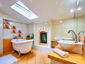A bathroom with a skylight, two sinks, a bathtub, and decorative tiles. - Large Holiday Home, Summer Pool, Sauna, Whirlpool (Choczewo)