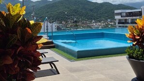 A rooftop pool with a clear view of a mountainous landscape. - Relax, Unwind and Experience Vallarta (Puerto Vallarta)