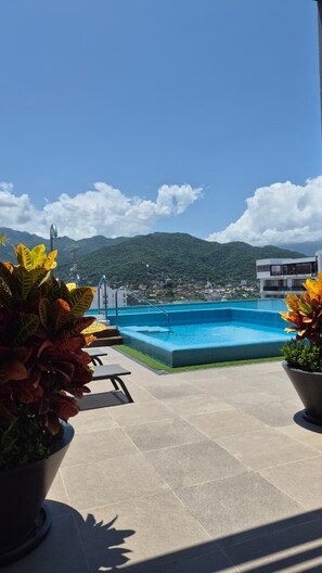 A rooftop pool with a clear view of a mountainous landscape. - Relax, Unwind and Experience Vallarta (Puerto Vallarta)