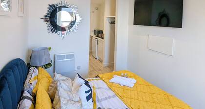A stylish modern studio stay near attractions with comfy room and vibrant design