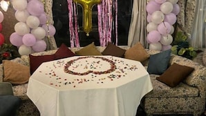 A round table with a white tablecloth, surrounded by a sofa with patterned cushions. - Timo Pyramids View : Deluxe Triple Room (Giza Governorate)