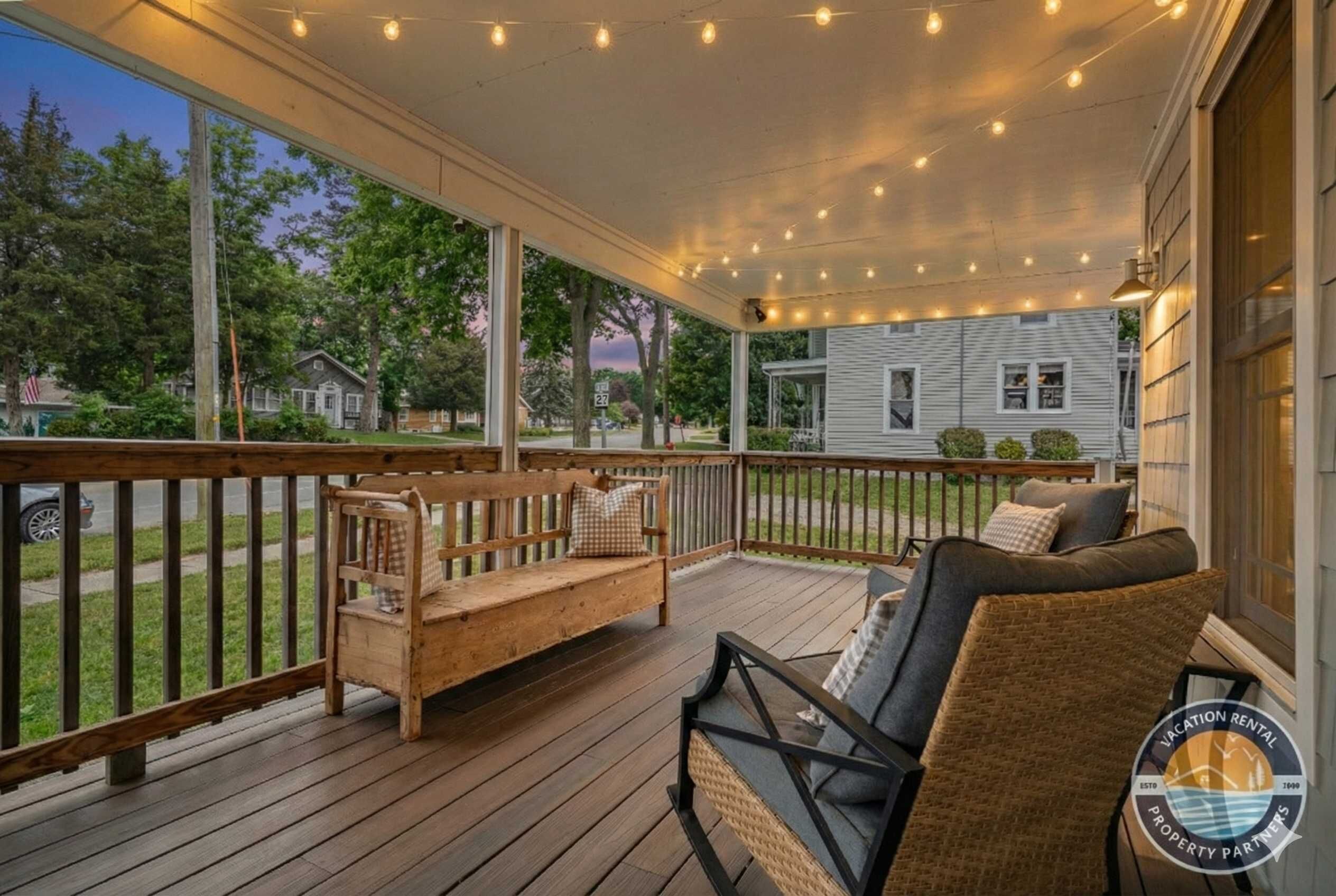 Magical outdoor deck draped in Edison string lights — the ultimate setting for warm summer evenings, al fresco dinners, backyard games, and stargazing with family and friends. Pure Lake Geneva living. Outdoor furniture included!