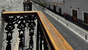 A street view with a white building on the left and a modern building on the right.