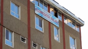 Un edificio de varios pisos con un letrero que indica la disponibilidad de habitaciones en el Hotel Celebrica.