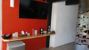 A compact kitchen area with a refrigerator, a coffee maker, and a small sink. - Acento House (Valle de Bravo)