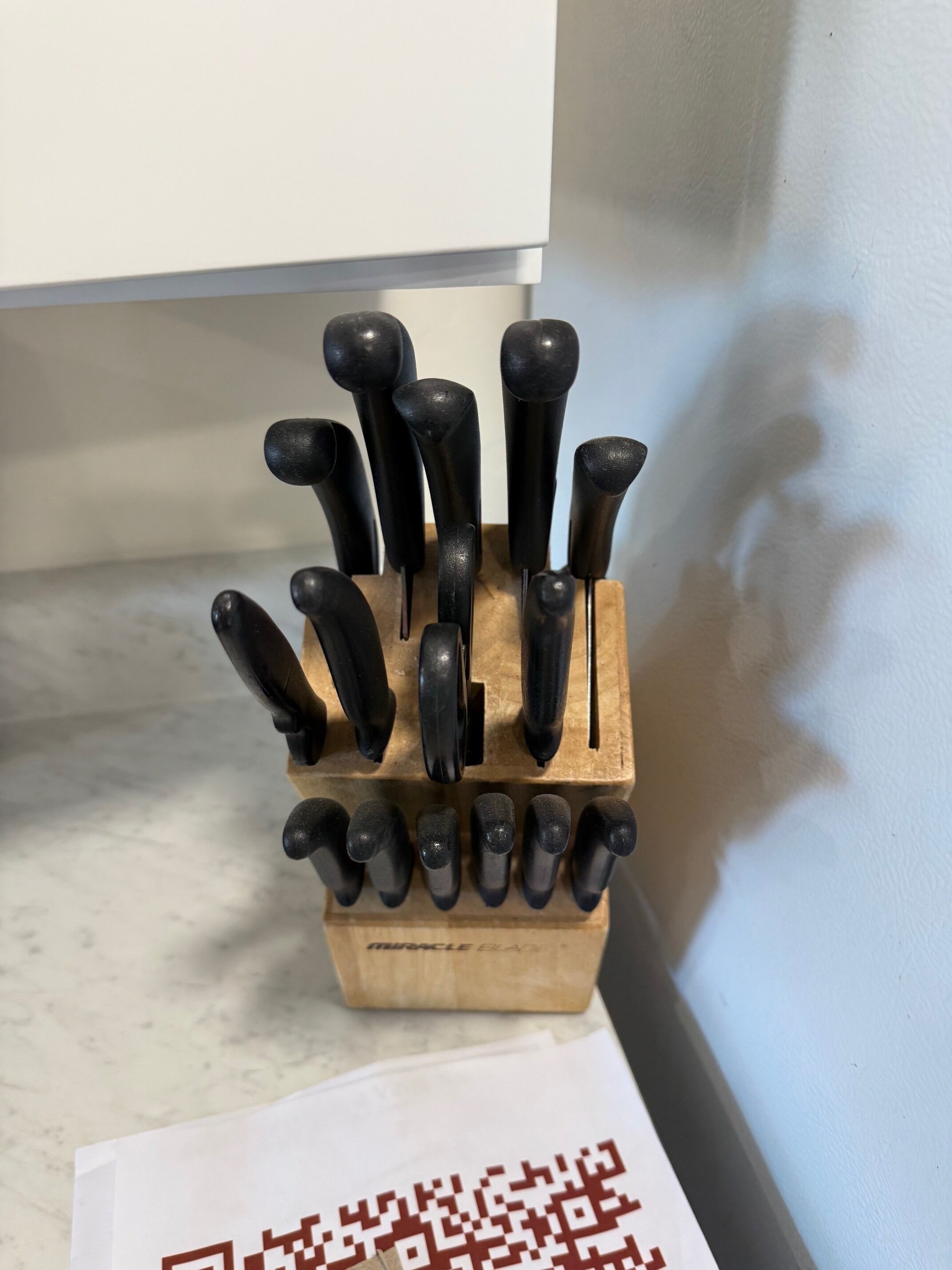 A knife block with multiple knives on a kitchen counter.