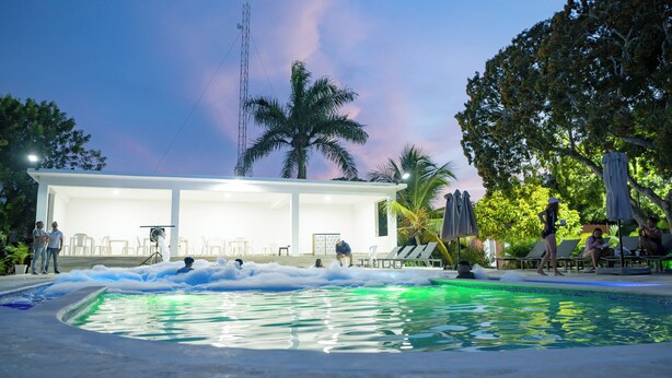 A pool area with lounge chairs and a covered seating area. - Hotel Boca de Yuma (Boca de Yuma)
