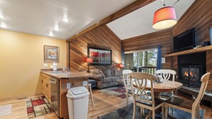 A cozy cabin interior with a kitchen, dining area, and fireplace. - Ski Access SS7B Retreat Pet Friendly  (Brian Head)