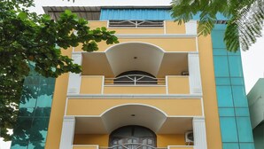 A multi-story building with a yellow facade, a balcony on the second floor, and a sign reading "Maruthi Residency". - Maruthi Residency (Puducherry)