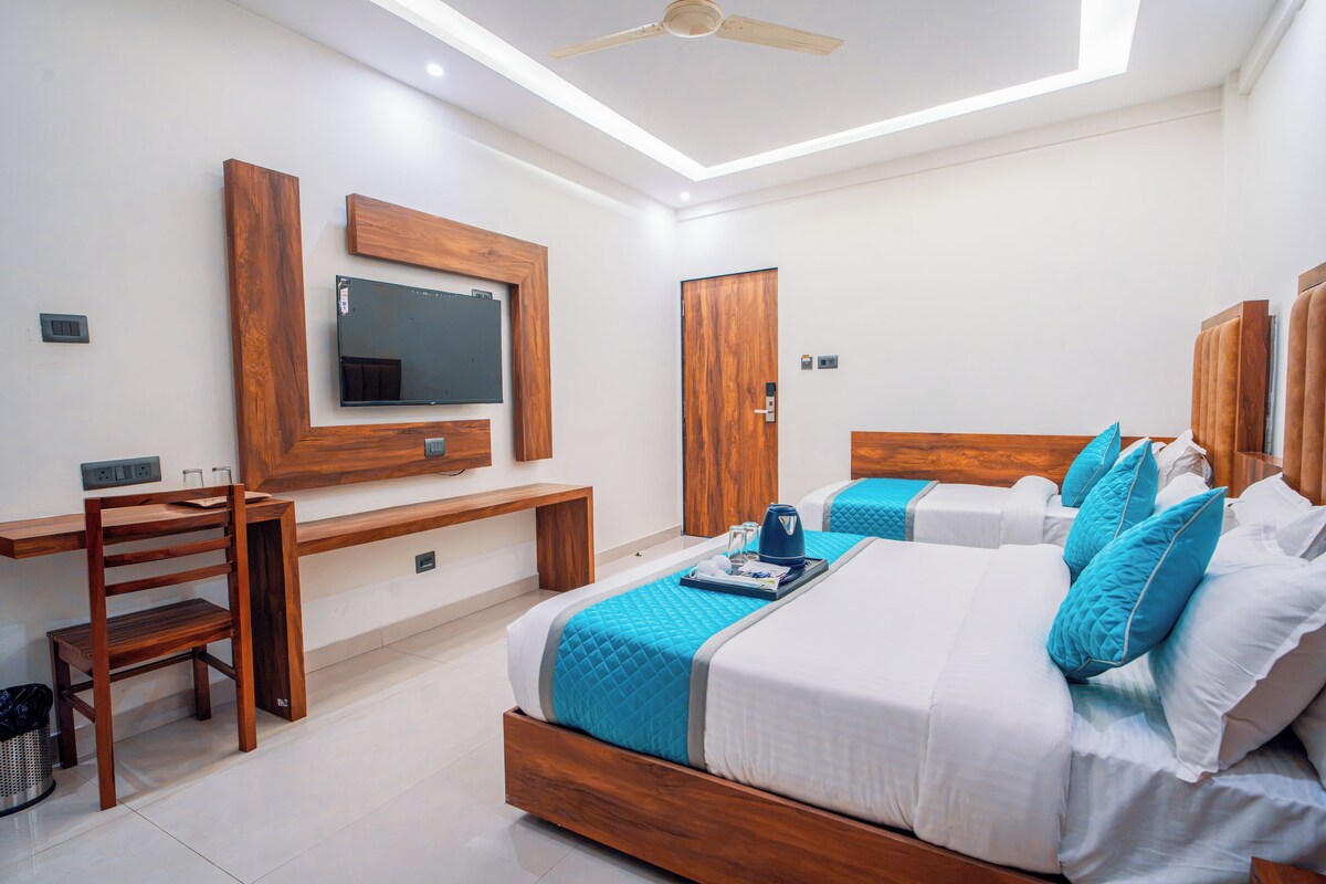 A hotel room with a bed, a desk, and a chair.