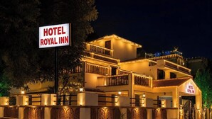 A hotel with a sign reading 'HOTEL ROYAL INN,' featuring a multi-story building with balconies and a gated entrance. - Hotel Royal Inn (Pune)