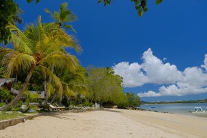 On the beach, white sand, sun loungers, snorkeling