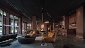 A modern lobby with a seating area, a bar, and large windows. - FunGee S Hotel Zhangjiajie National Park (Zhangjiajie)