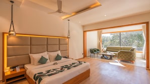 A modern hotel room with a large bed, a ceiling fan, and a balcony with seating. - Moustache Select Nainital (Nainital, Uttarakhand)