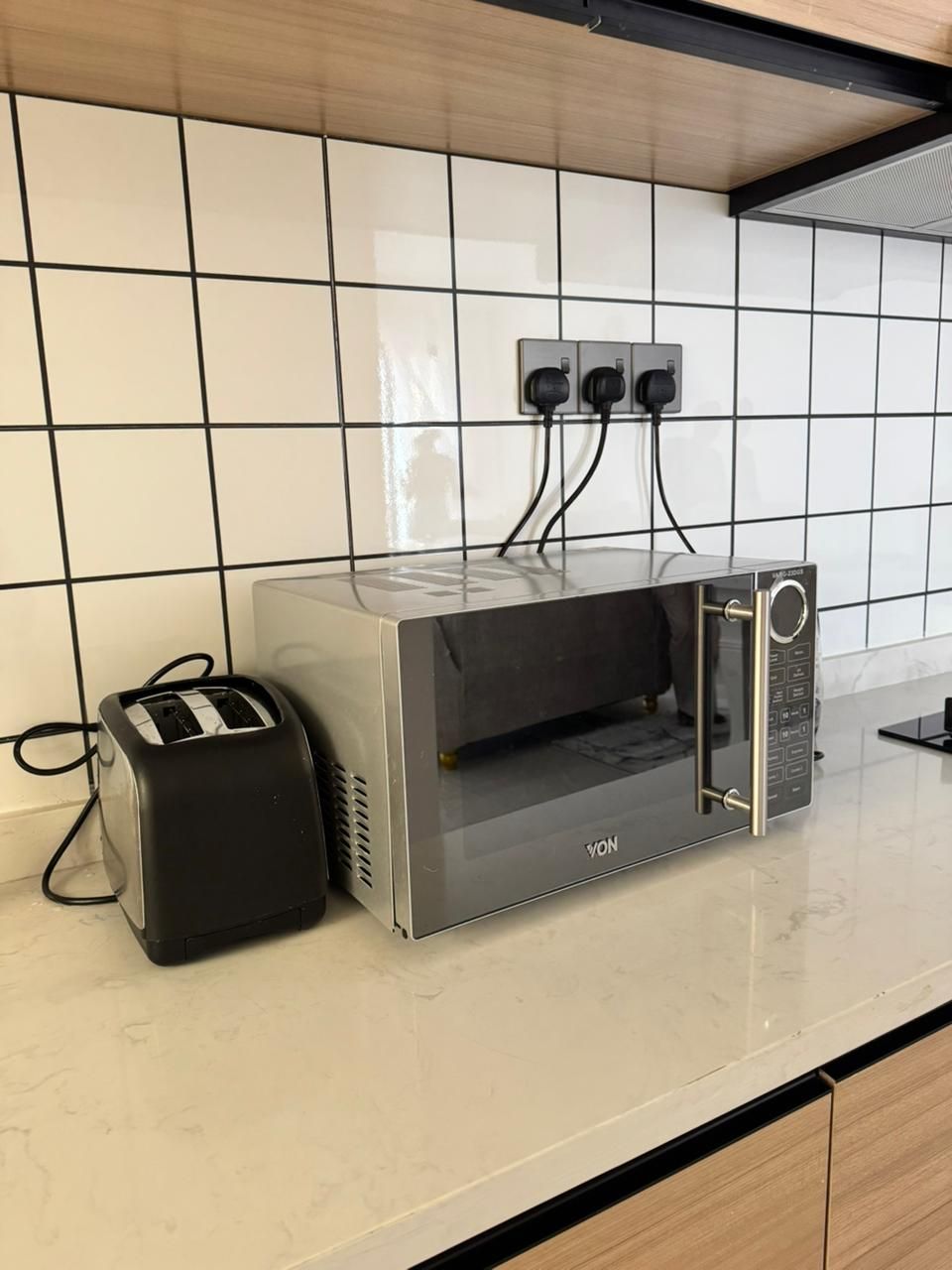 A kitchen with a toaster and a microwave on a countertop.