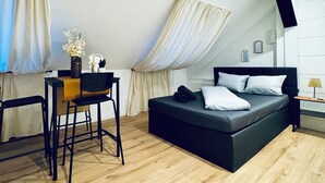 Un dormitorio moderno con cama, escritorio y silla.