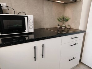 Fridge, microwave, stovetop, coffee/tea maker