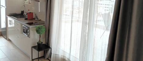 Fridge, microwave, coffee/tea maker, cookware/dishes/utensils