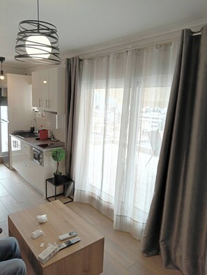 Fridge, microwave, coffee/tea maker, cookware/dishes/utensils