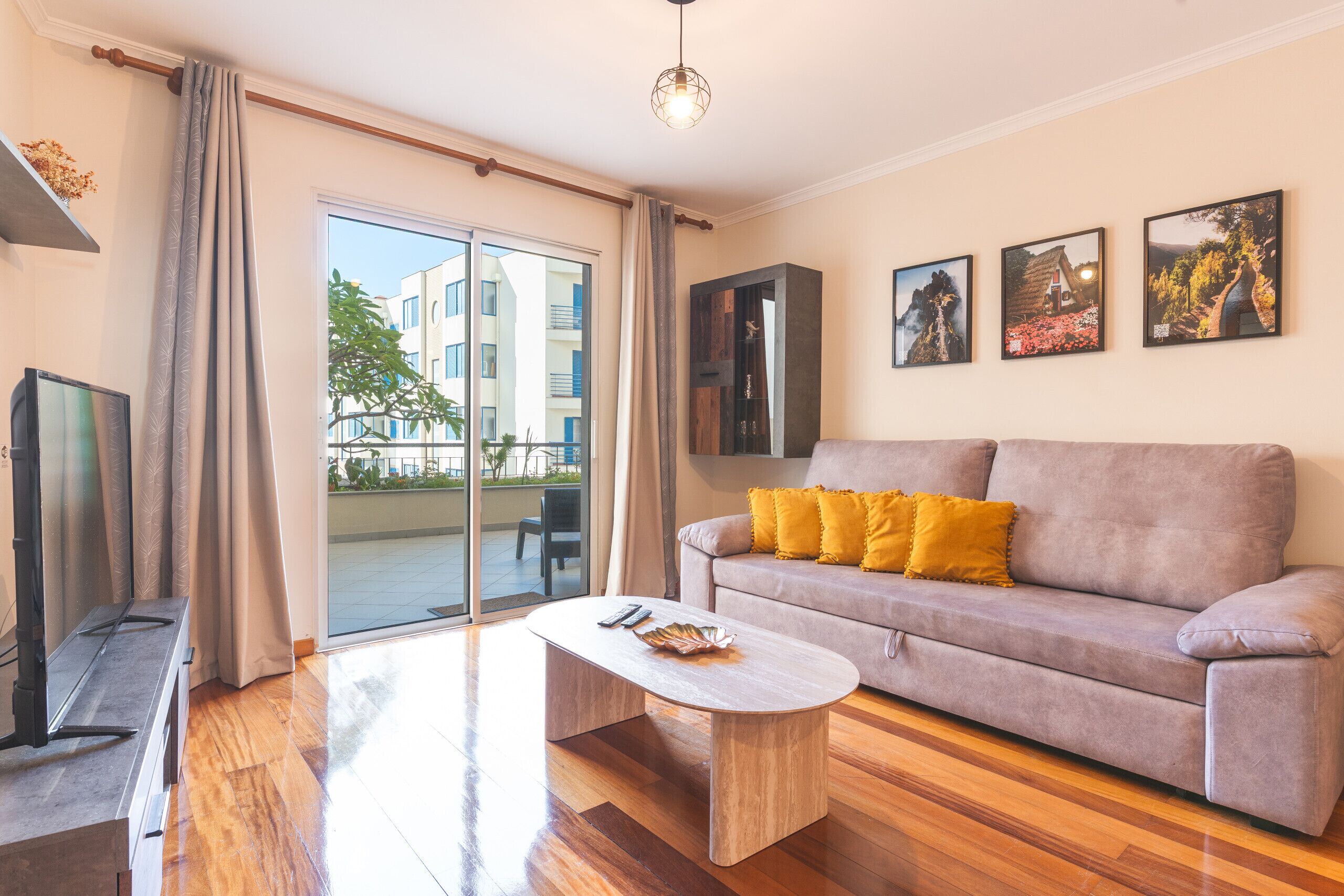 A modern living room with a sofa, coffee table, and a television.
