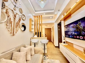 Comfort Condo, 2 Bedrooms, Balcony, Pool View | Living room | 32-inch Smart TV with digital channels, books - Cozy and Comfy Retreat with Balcony (Parañaque)