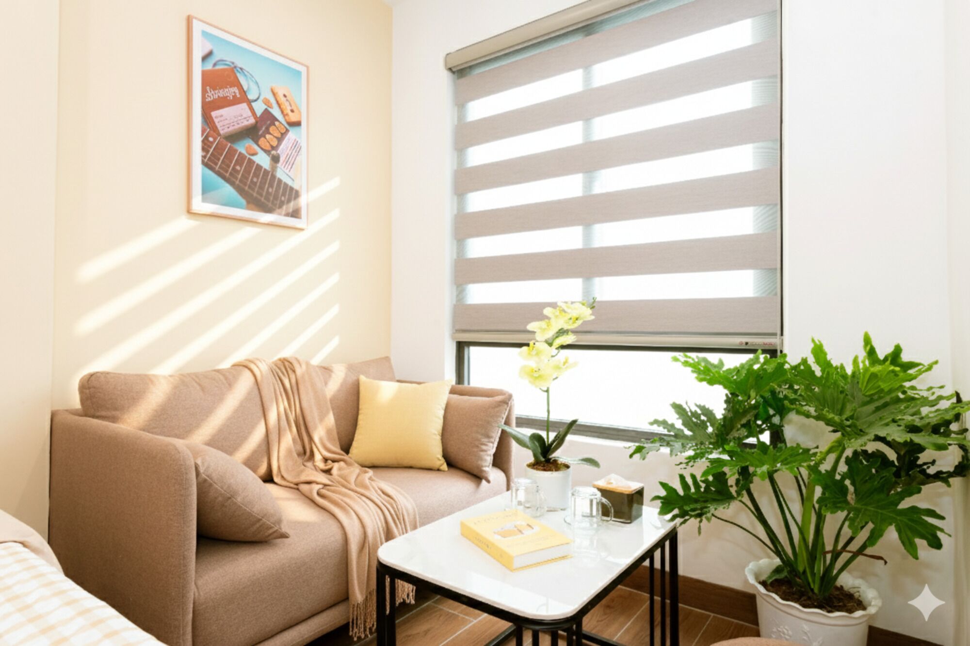 A living room with a beige sofa, a coffee table, a potted plant, and a window with blinds.