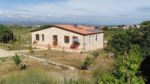 A stone house with a tiled roof and a small garden area. - Bed@Breakfast, 2 double rooms, 1 apartment for 6-8 persons (Kryevidh)