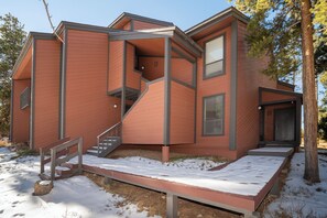 A modern house with a staircase leading to a second floor, a front porch, and a garage. - Sunsong 3F New split-level 3 bedroom in Fraser with private deck (Fraser)