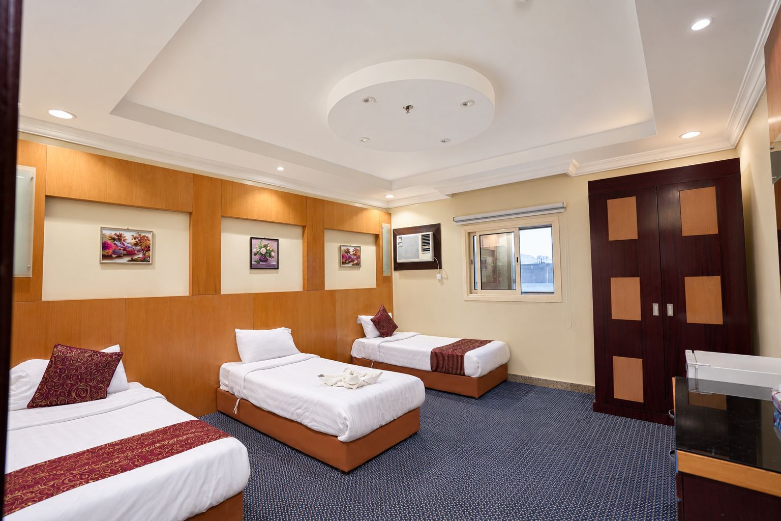 Ein Hotelzimmer mit zwei Betten, einem Schreibtisch und einem Fenster mit Blick.