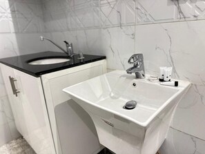 Tina y regadera independientes y pantuflas 