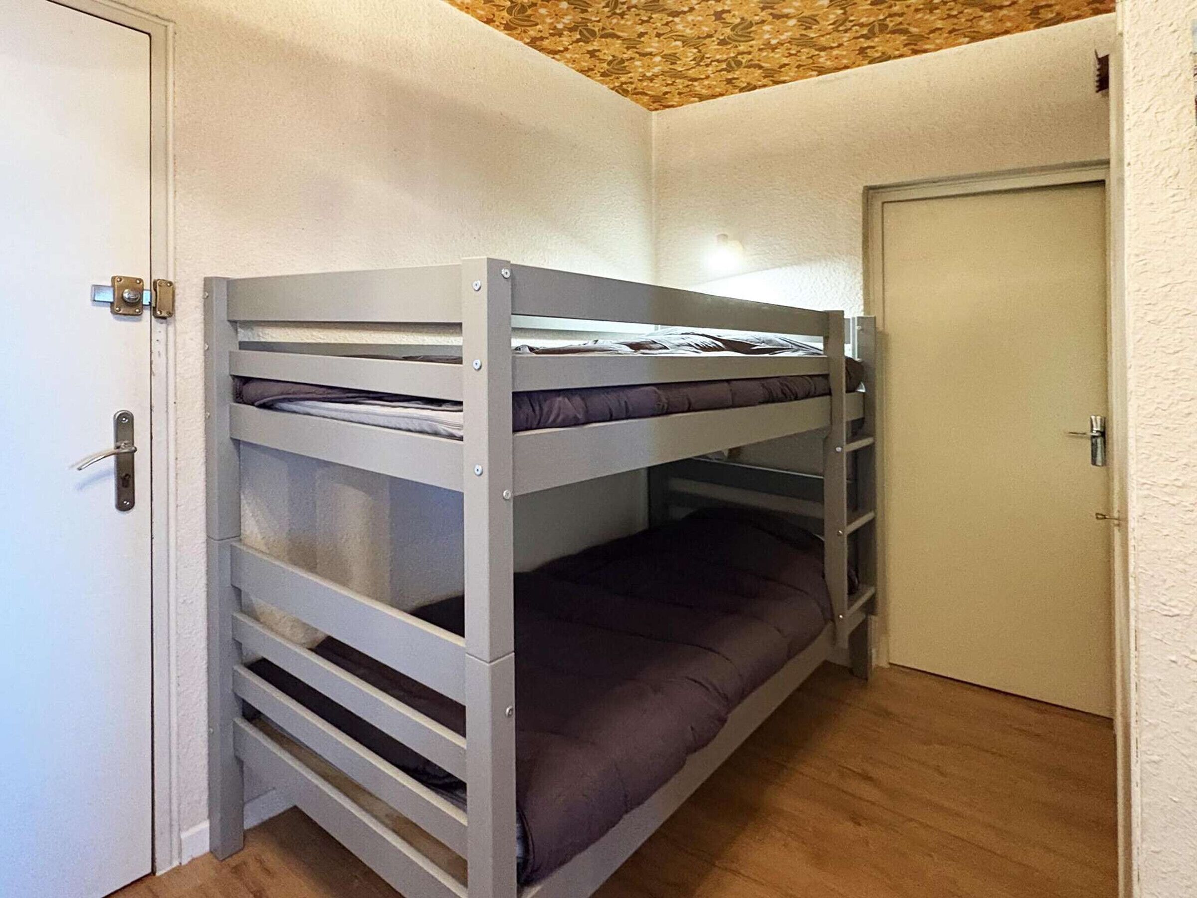 A bunk bed with a door on the left and a door on the right.