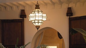 A traditional interior with a fountain, a potted plant, and a hanging light fixture. - Riad Mint  (Marrakech)