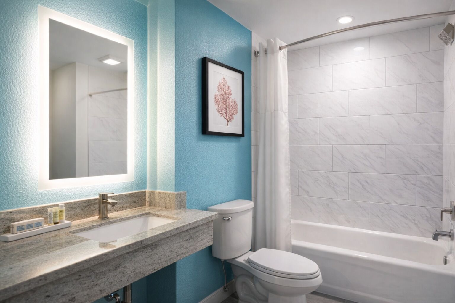A bathroom with a sink, toilet, and shower.