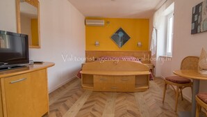 A compact room with a bed, a TV, a small table, and a chair. - Pansion Saturn / Pansion Saturn soba 26 -sea view (Veli Lošinj)