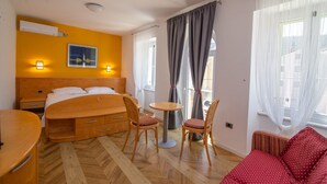 A hotel room with a bed, bedside tables, a chair, a small table, and a sofa. - Pansion Saturn / Pansion Saturn soba 16 - seaview (Veli Lošinj)