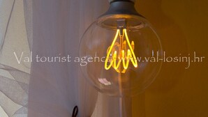 A clear glass light fixture with a visible filament bulb. - Pansion Saturn / Pansion Saturn 15 (Veli Lošinj)